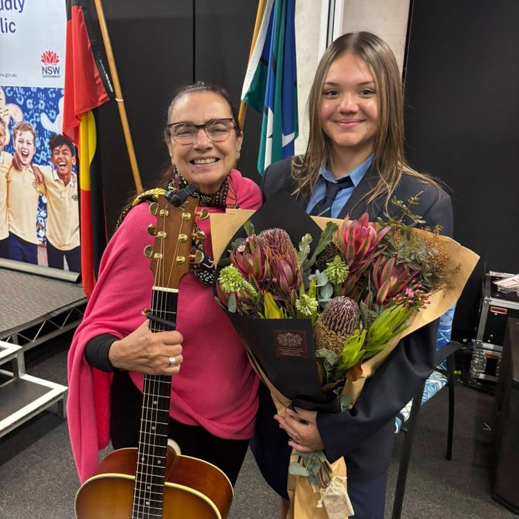 Kyla Roberts with flowers and Michele Hall Executive Director Aboriginal Education and Communities