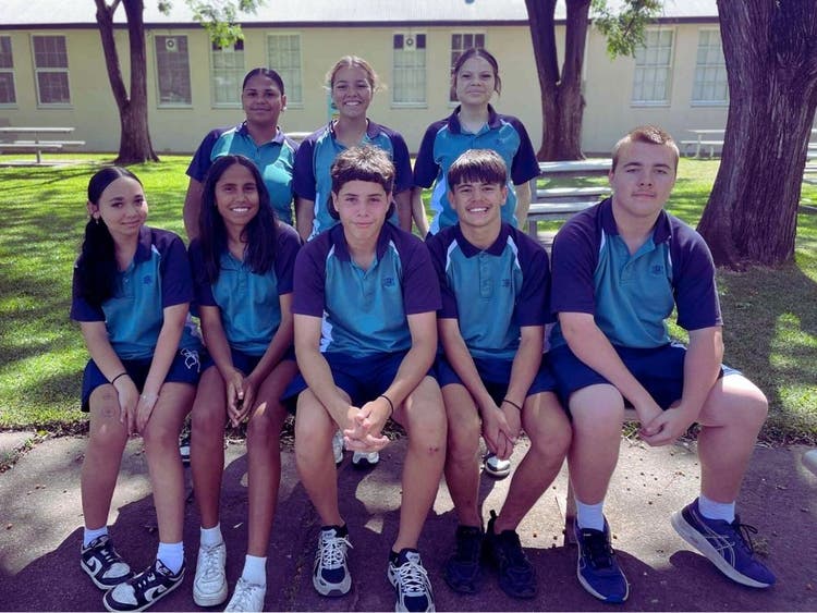 A number of students sitting on a bench